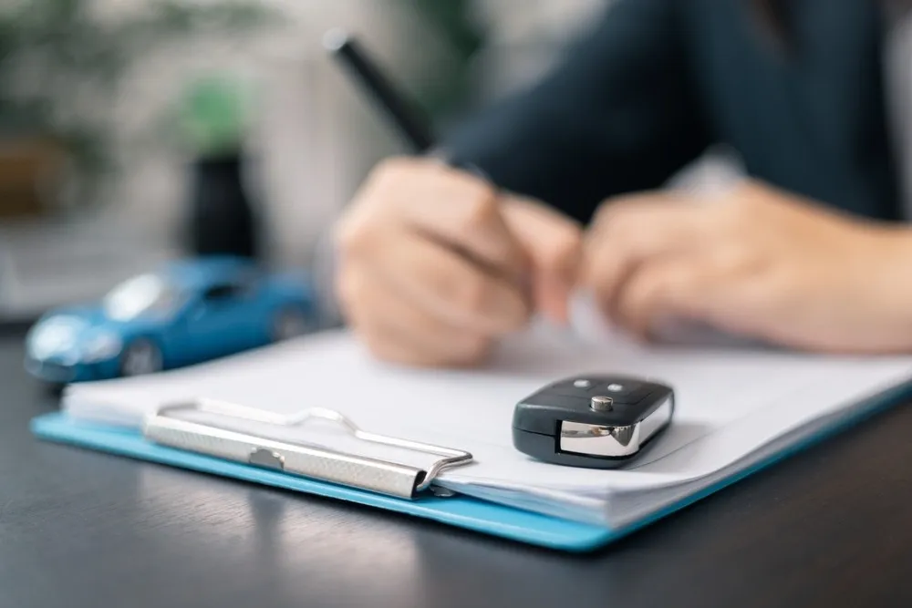 Keys being handed over after a vehicle purchase
